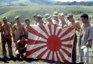 c American soldiers holding captured Japanese flag on Guadalcanal Island during WWII. Photo by Frank Scherschel